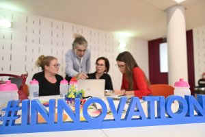 Members of ETF's excellence network discussing ideas with an innovation sign on the desk